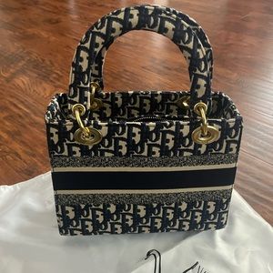 Dark blue and tan bag with strap